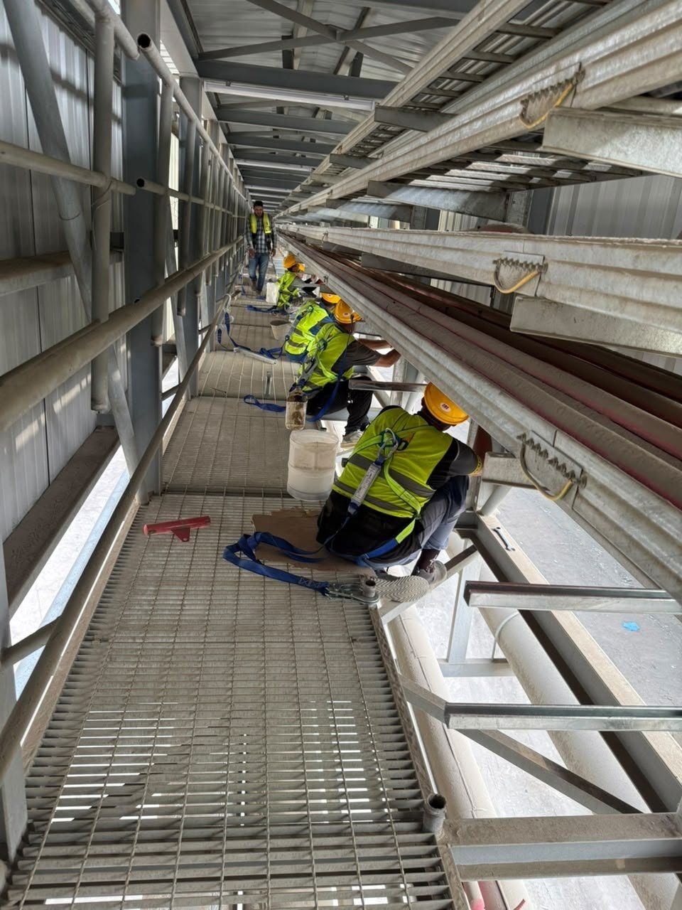 Crew pulling MV cables along cable ladder